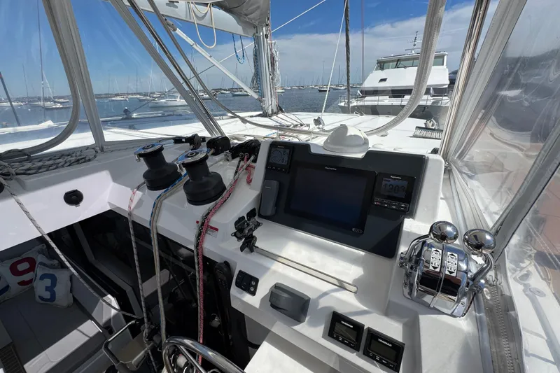 Jolly Time Yacht Photos Pics Cockpit of 2021 Leopard 42 yacht with navigation equipment and marina view.