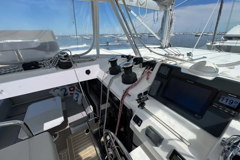 Jolly Time Yacht Photos Pics 2021 Leopard 42 yacht cockpit with navigation equipment and winches, docked in a marina.