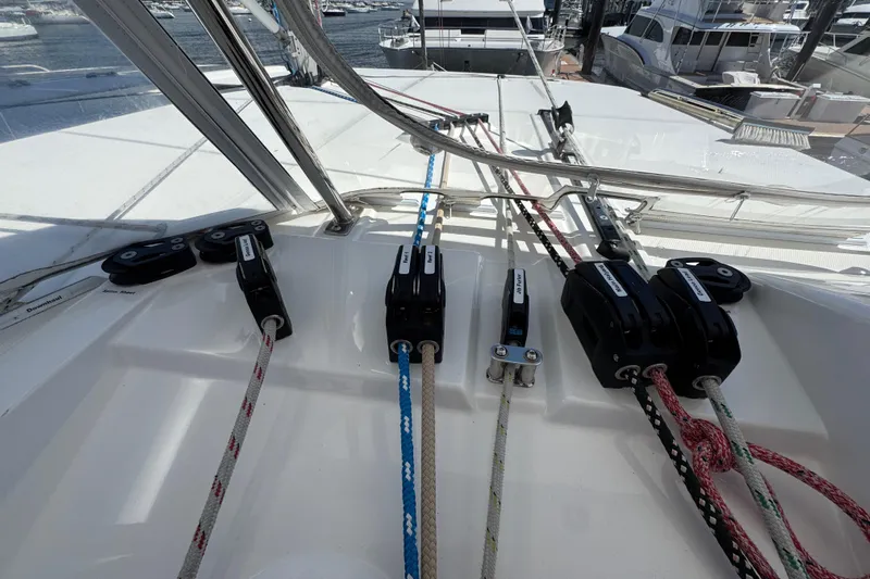 Jolly Time Yacht Photos Pics Sailing ropes and pulleys on a 2021 Leopard 42 catamaran deck at a marina.
