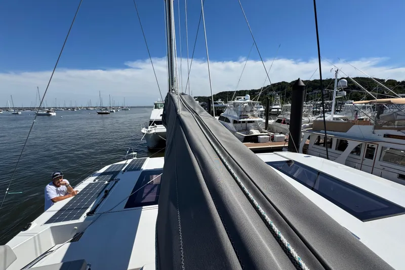 Jolly Time Yacht Photos Pics 2021 Leopard 42 catamaran docked at marina with solar panels and clear blue sky.