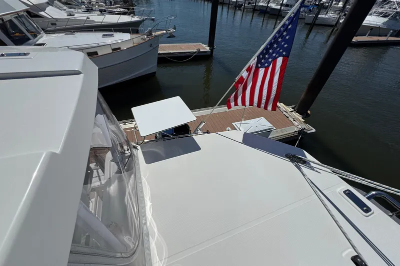 Jolly Time Yacht Photos Pics Leopard 42 yacht docked, displaying American flag, surrounded by other boats.