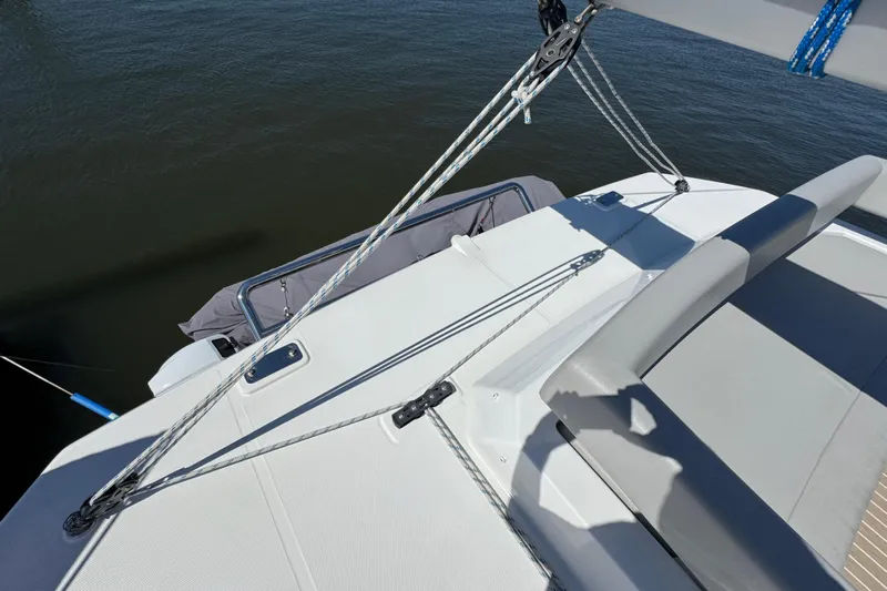 Jolly Time Yacht Photos Pics 2021 Leopard 42 catamaran deck with seating and rigging, overlooking water.