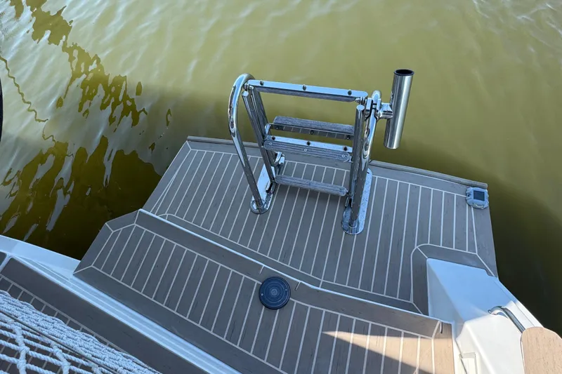 Jolly Time Yacht Photos Pics Leopard 42 yacht swim platform with ladder, 2021 model, on calm water.