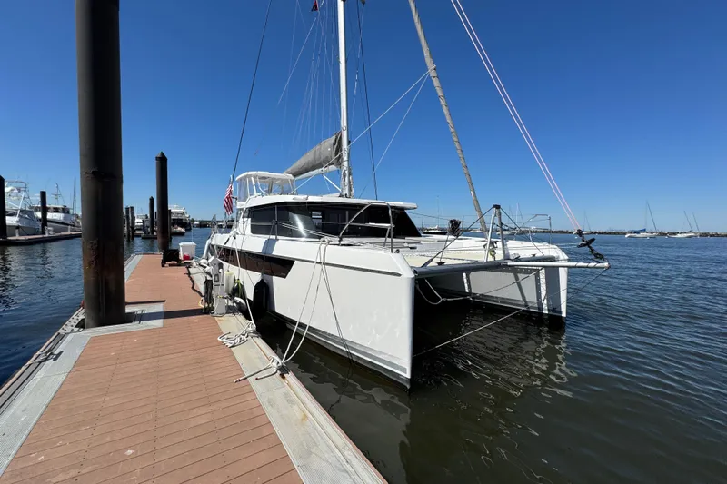 Jolly Time Yacht Photos Pics 2021 Leopard 42 catamaran docked at marina under clear blue sky.