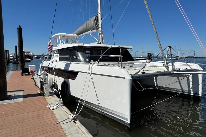 Jolly Time Yacht Photos Pics 2021 Leopard 42 catamaran docked at marina under clear blue sky.