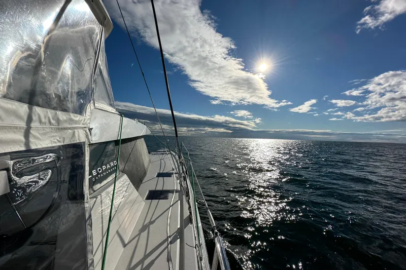 Jolly Time Yacht Photos Pics Sailing on a 2021 Leopard 42 catamaran under a bright sunlit sky.