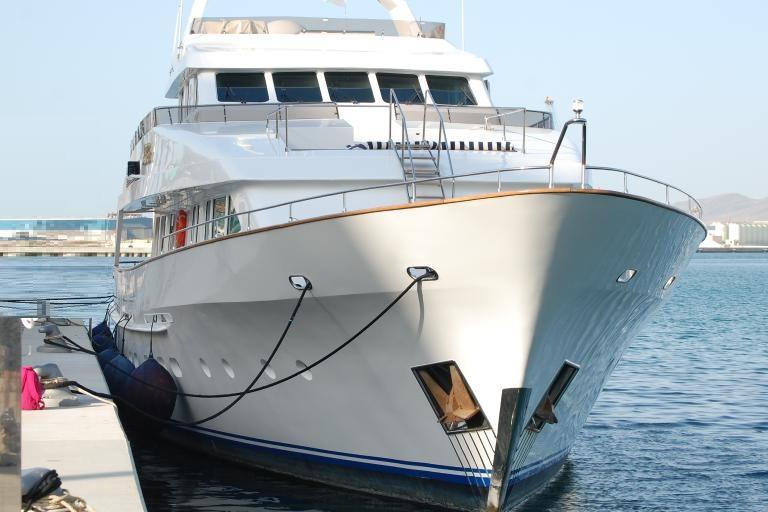 Luxurious 1991 Explorer Trawler tri-deck yacht docked at marina.