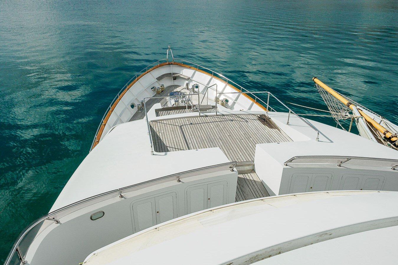 Bow view of 1991 Explorer Trawler tri deck 110' yacht on calm water.