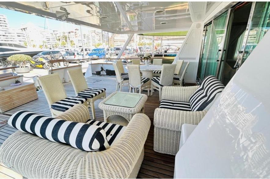 Luxurious deck of 1991 Explorer Trawler tri deck 110' with elegant wicker furniture.