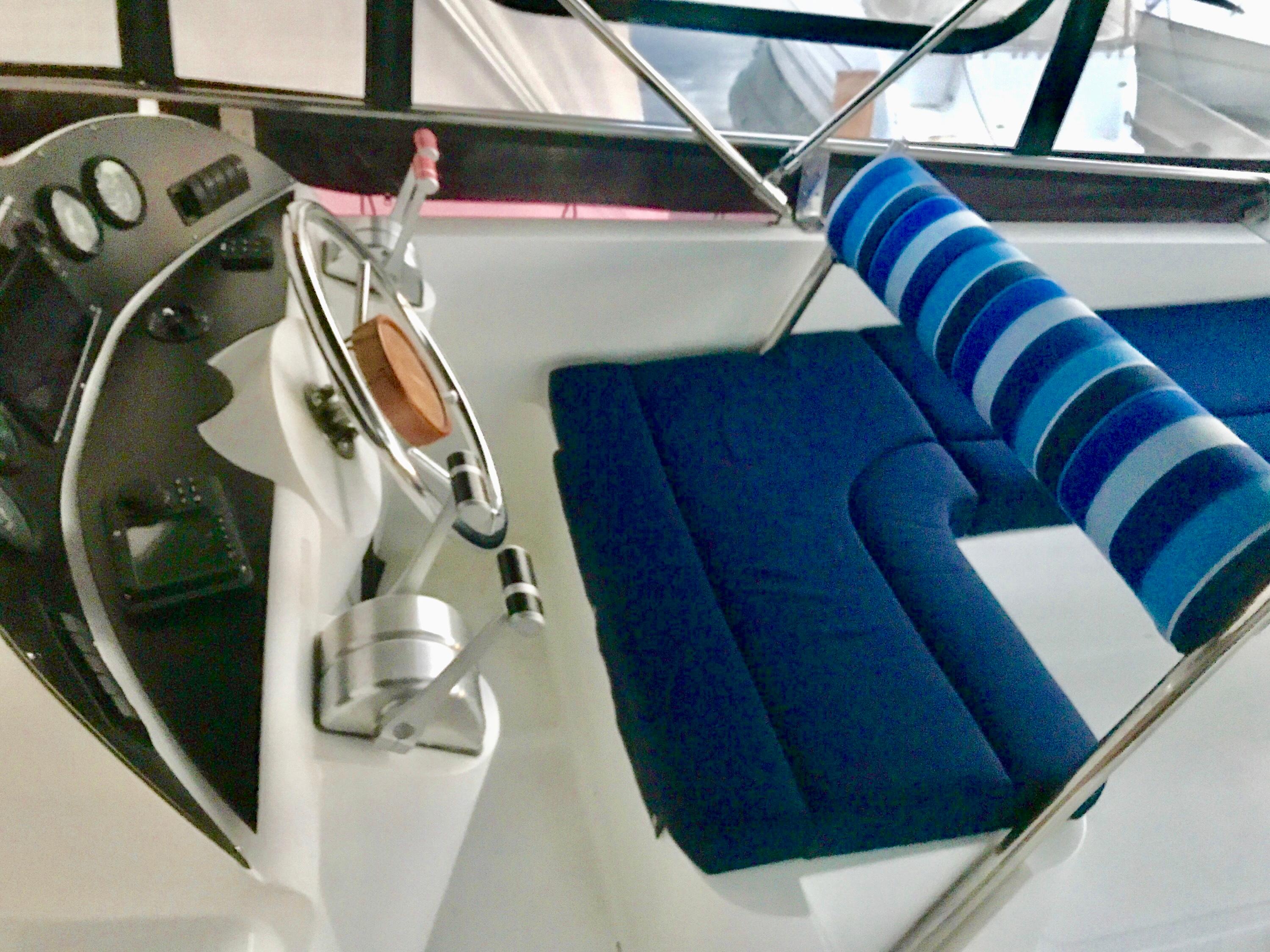 Control panel and seating area of a 1999 Prima 5230 boat.