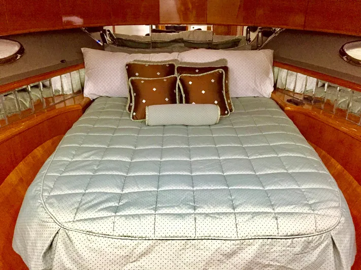  Yacht Photos Pics Luxurious Prima 5230 yacht bedroom with elegant bedding and decorative pillows, 1999 model.