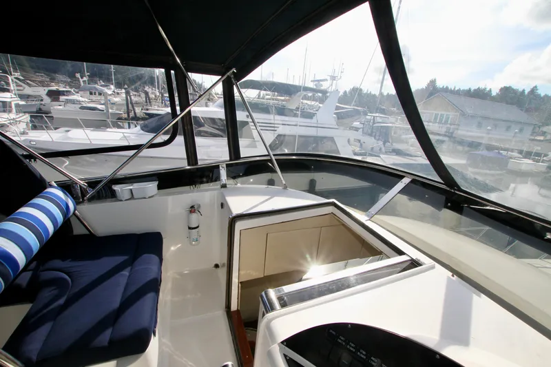  Yacht Photos Pics Interior view of a 1999 Prima 5230 boat with marina background.