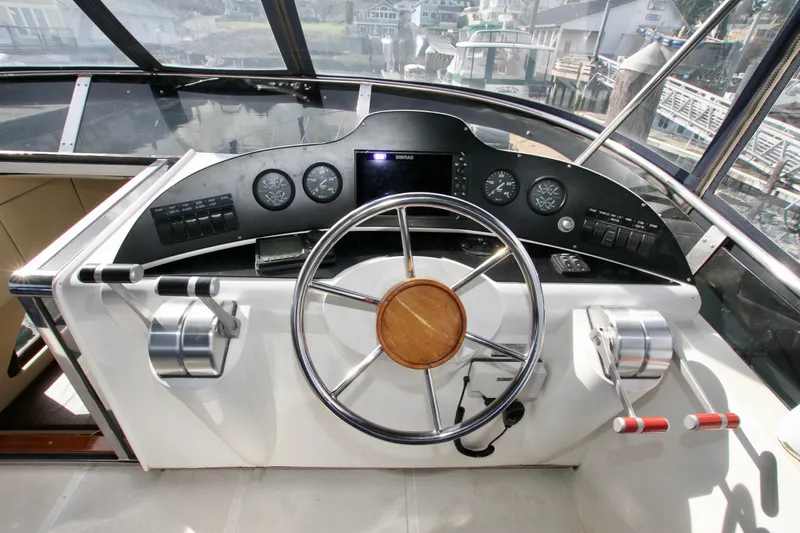  Yacht Photos Pics Boat cockpit with steering wheel and controls, Prima 5230, 1999 model, docked at marina.