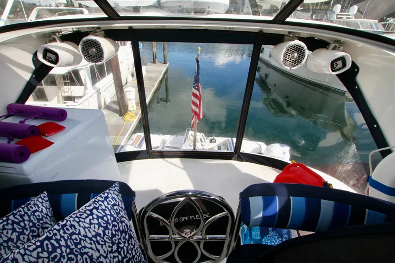  Yacht Photos Pics Interior view of a 1999 Prima 5230 boat with American flag and marina.