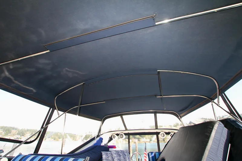  Yacht Photos Pics Interior view of a 1999 Prima 5230 boat with blue canopy and seating.