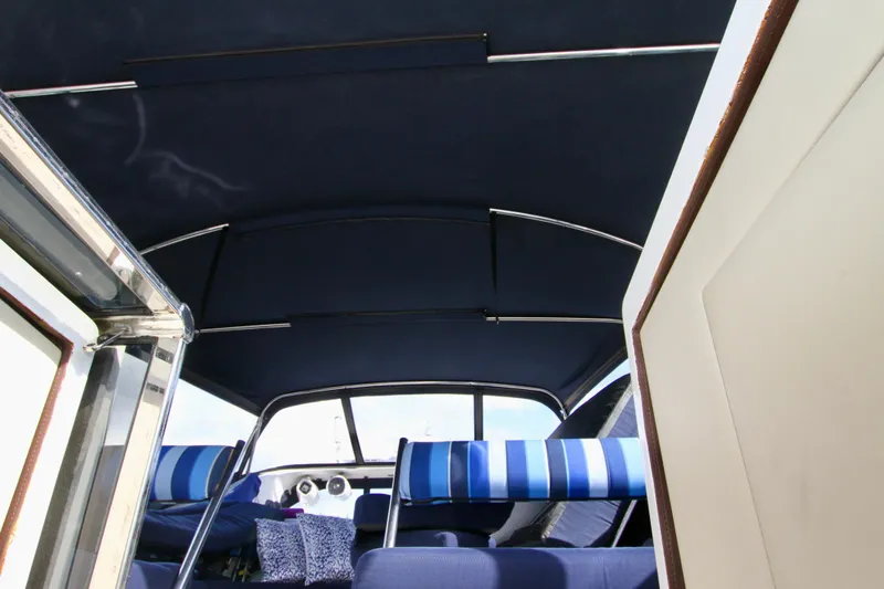  Yacht Photos Pics Interior view of a 1999 Prima 5230 boat with blue seating and canopy.