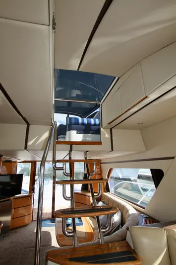  Yacht Photos Pics Interior of a 1999 Prima 5230 yacht with modern staircase and seating area.