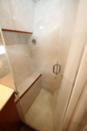  Yacht Photos Pics Compact shower with glass door and wooden accents in a Prima 5230, 1999 model.