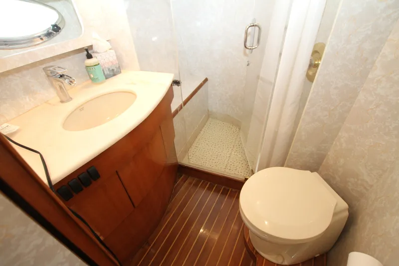  Yacht Photos Pics Compact bathroom in a 1999 Prima 5230 yacht with shower, sink, and toilet.