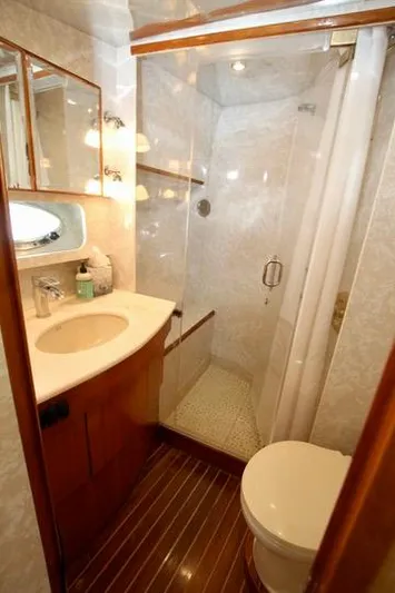  Yacht Photos Pics Compact boat bathroom with shower, sink, and toilet in a Prima 5230, 1999 model.