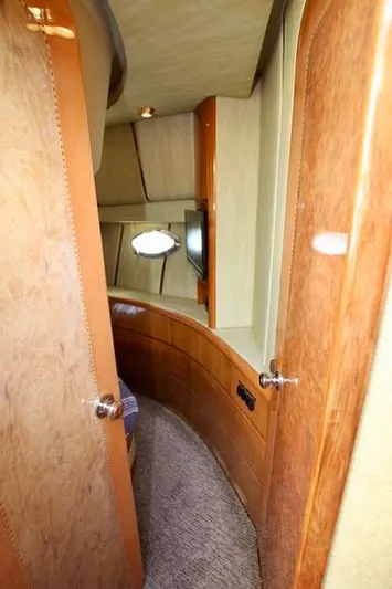  Yacht Photos Pics Interior of a 1999 Prima 5230 yacht with wooden doors and carpeted hallway.