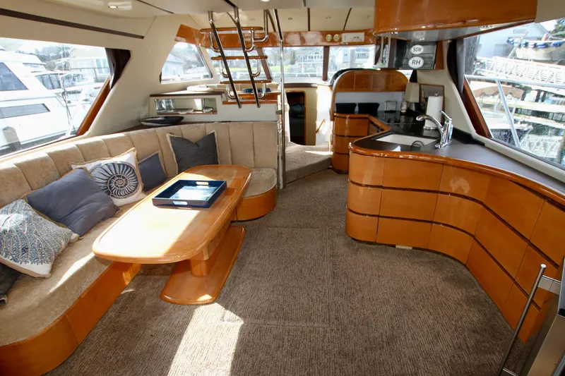  Yacht Photos Pics Luxurious Prima 5230 yacht interior, featuring elegant wood finishes and comfortable seating, 1999 model.