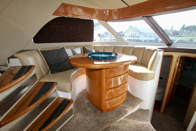  Yacht Photos Pics Luxurious Prima 5230 yacht interior with elegant seating and wooden table, 1999 model.
