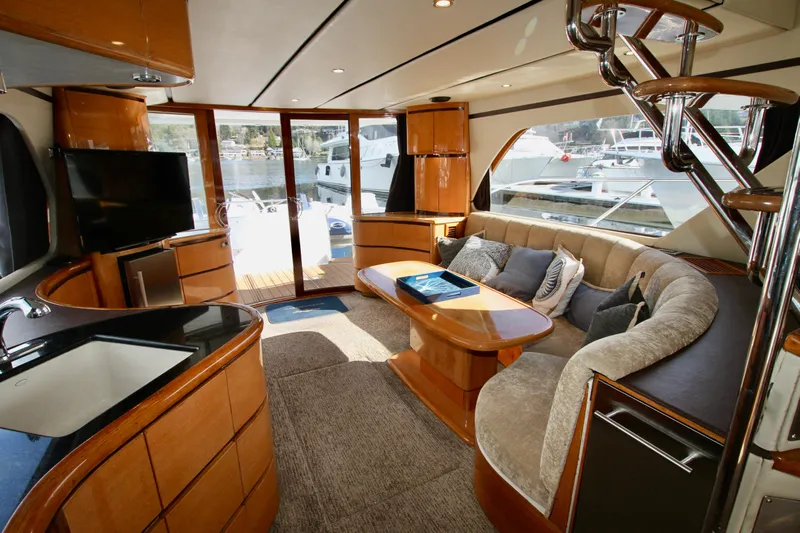  Yacht Photos Pics Luxurious interior of a 1999 Prima 5230 yacht with modern furnishings and large windows.