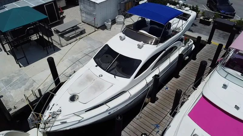  Yacht Photos Pics Azimut 46 yacht from 2000 docked with blue canopy, aerial view.