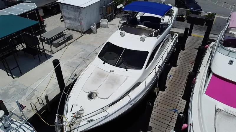  Yacht Photos Pics Azimut 46 yacht from 2000 docked at a marina with blue canopy.