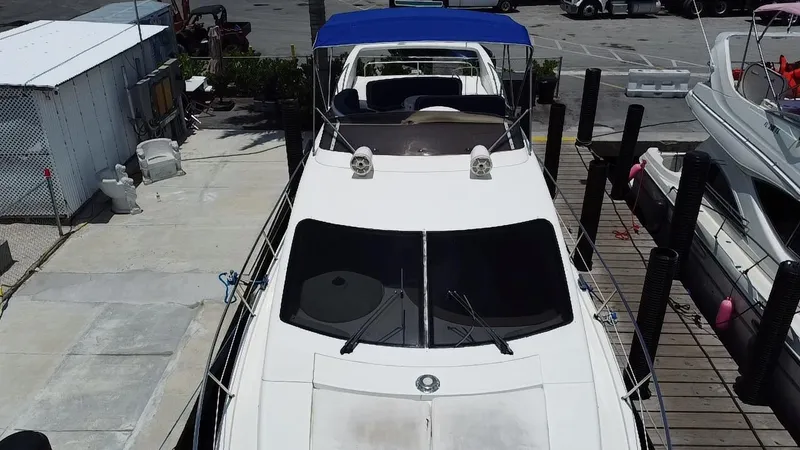  Yacht Photos Pics Azimut 46 yacht from 2000 docked, featuring a blue canopy and sleek design.