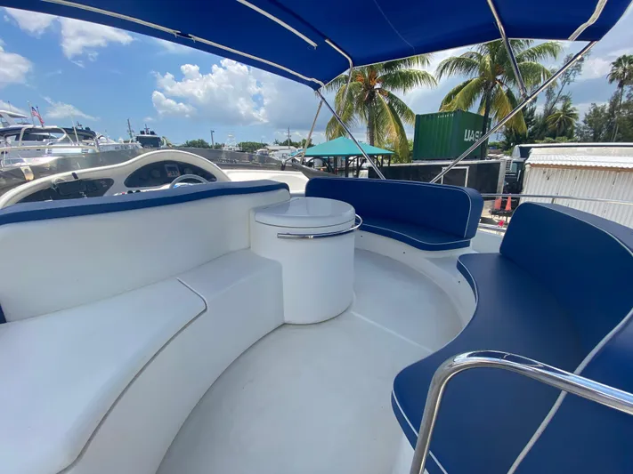  Yacht Photos Pics Azimut 46 yacht interior, 2000 model, featuring blue and white seating under a canopy.