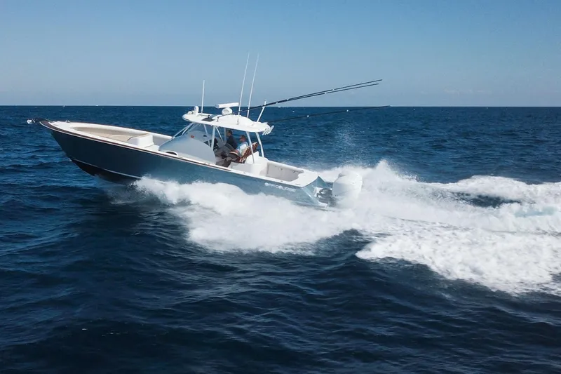  Yacht Photos Pics 2018 Winter Custom Yachts Center Console cruising on open ocean waters.