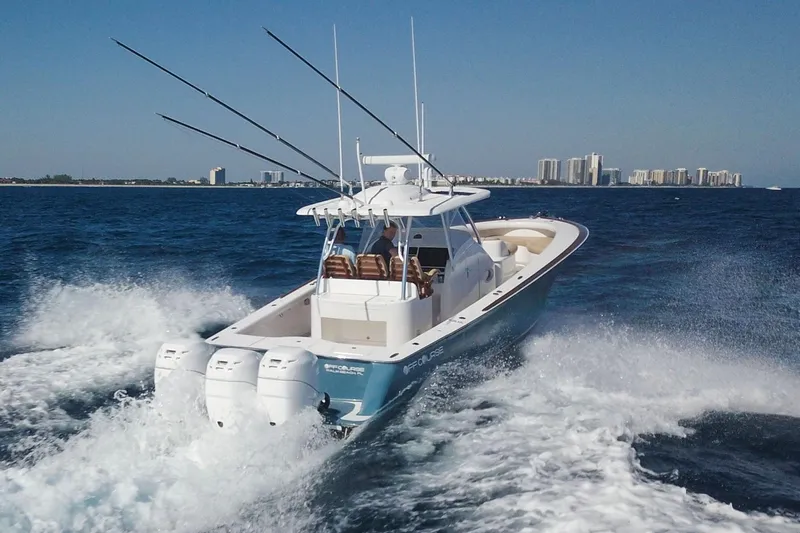  Yacht Photos Pics 2018 Winter Custom Yachts Center Console cruising on ocean with city skyline in background.