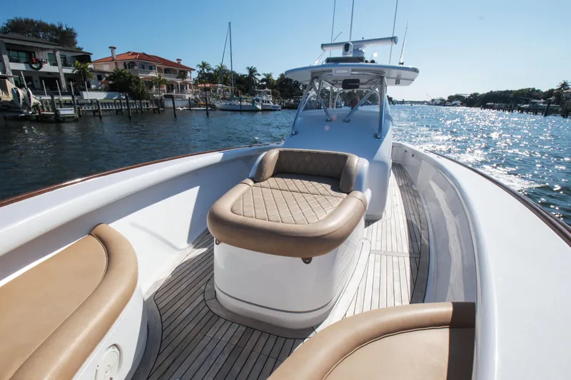  Yacht Photos Pics 2018 Winter Custom Yachts Center Console on sunny waterfront, featuring luxurious seating.