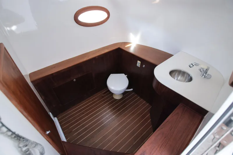  Yacht Photos Pics 2018 Winter Custom Yachts Center Console bathroom with wooden accents and modern fixtures.
