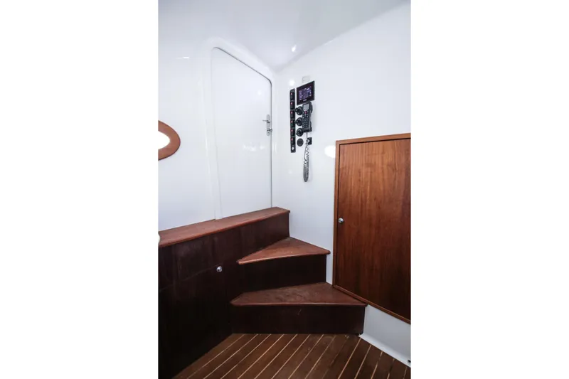  Yacht Photos Pics Interior of 2018 Winter Custom Yachts Center Console with wooden stairs and control panel.