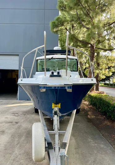  Yacht Photos Pics 2023 NJM NSB-28 boat on trailer, parked outdoors near a building and tree.