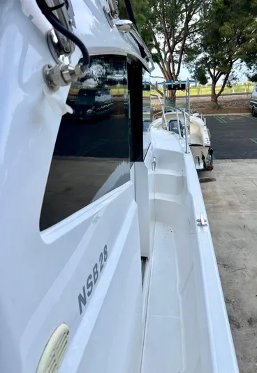  Yacht Photos Pics 2023 NJM NSB-28 boat docked, showcasing sleek design and modern features.