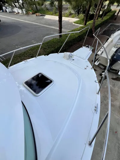  Yacht Photos Pics 2023 NJM NSB-28 boat deck with railing and hatch, docked near trees.