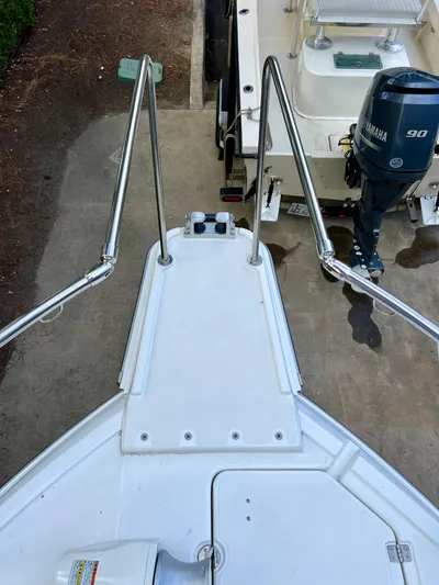  Yacht Photos Pics Bow view of 2023 NJM NSB-28 boat with stainless steel railings and Yamaha outboard motor.