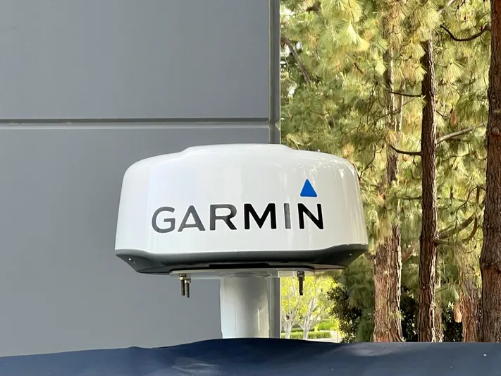  Yacht Photos Pics Garmin radar device mounted outdoors, NJM NSB-28 model, 2023, near trees and building.
