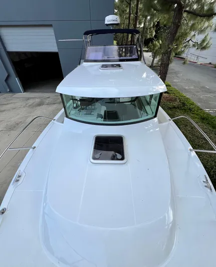  Yacht Photos Pics 2023 NJM NSB-28 boat docked near industrial building and trees.