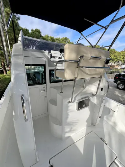  Yacht Photos Pics 2023 NJM NSB-28 boat interior with seating and canopy, parked outdoors.