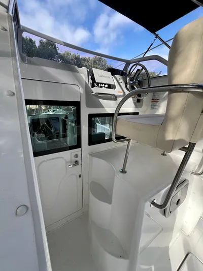  Yacht Photos Pics 2023 NJM NSB-28 boat helm with steering wheel and control panel.