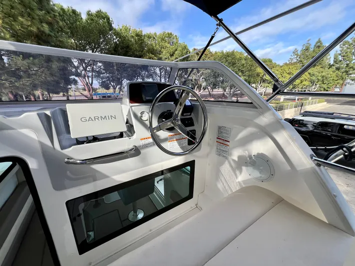  Yacht Photos Pics 2023 NJM NSB-28 boat cockpit with Garmin navigation system and steering wheel.