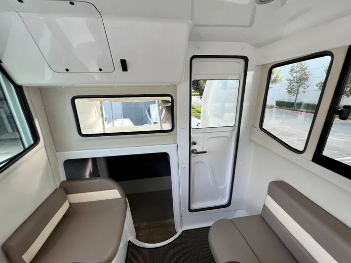  Yacht Photos Pics Interior of 2023 NJM NSB-28 boat with seating and windows.