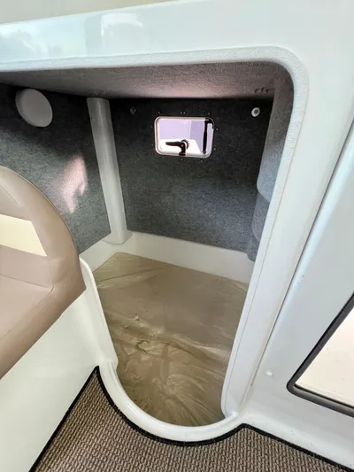  Yacht Photos Pics 2023 NJM NSB-28 interior cabin with window, featuring compact design and carpeted flooring.