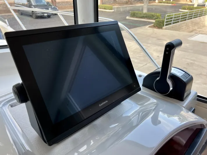  Yacht Photos Pics Control panel of NJM NSB-28 boat, featuring a Garmin display and throttle lever, 2023 model.