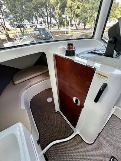  Yacht Photos Pics Interior of 2023 NJM NSB-28 boat with seating and control panel.